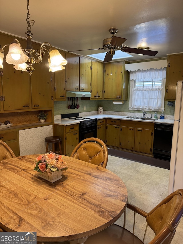 kitchen featuring sink, decorative light fixtures, light tile patterned floors, ceiling fan, and black appliances