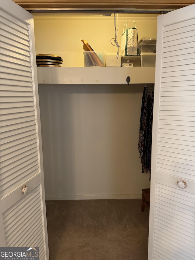 spacious closet featuring dark carpet