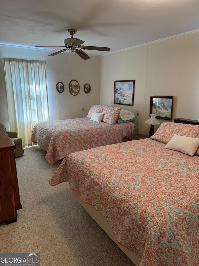 carpeted bedroom with crown molding and ceiling fan