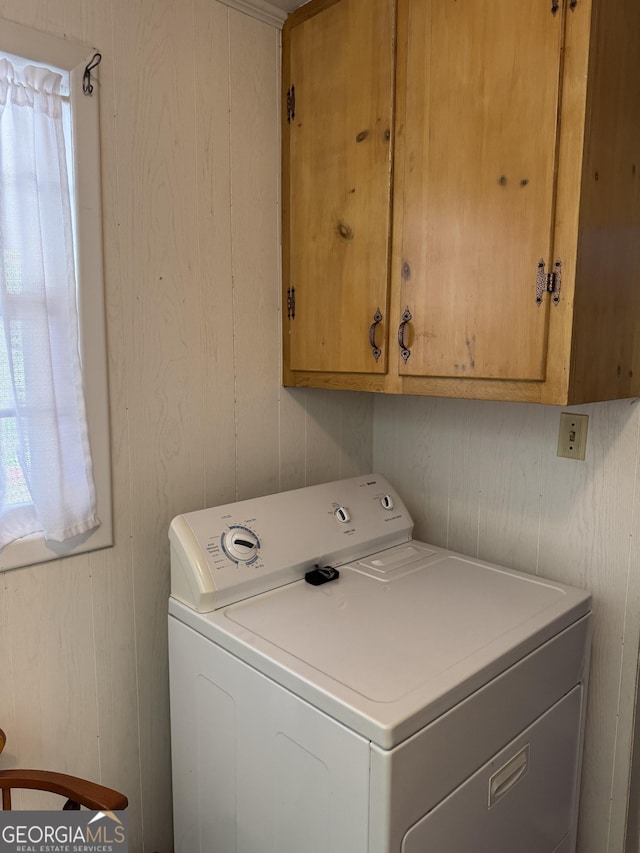 laundry room featuring cabinets and washer / clothes dryer