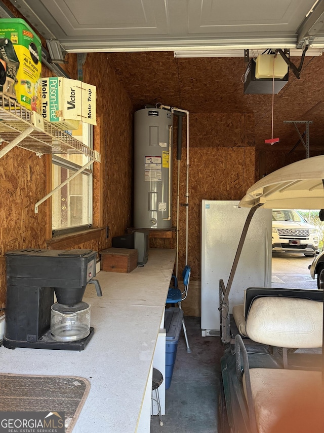 interior space with a garage door opener, electric water heater, and a wood stove