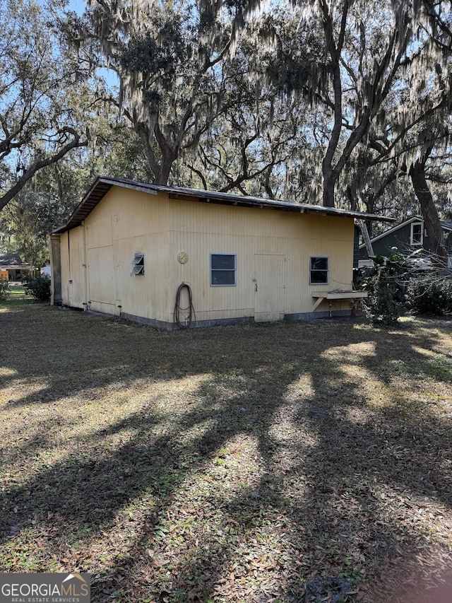 view of side of home with a lawn