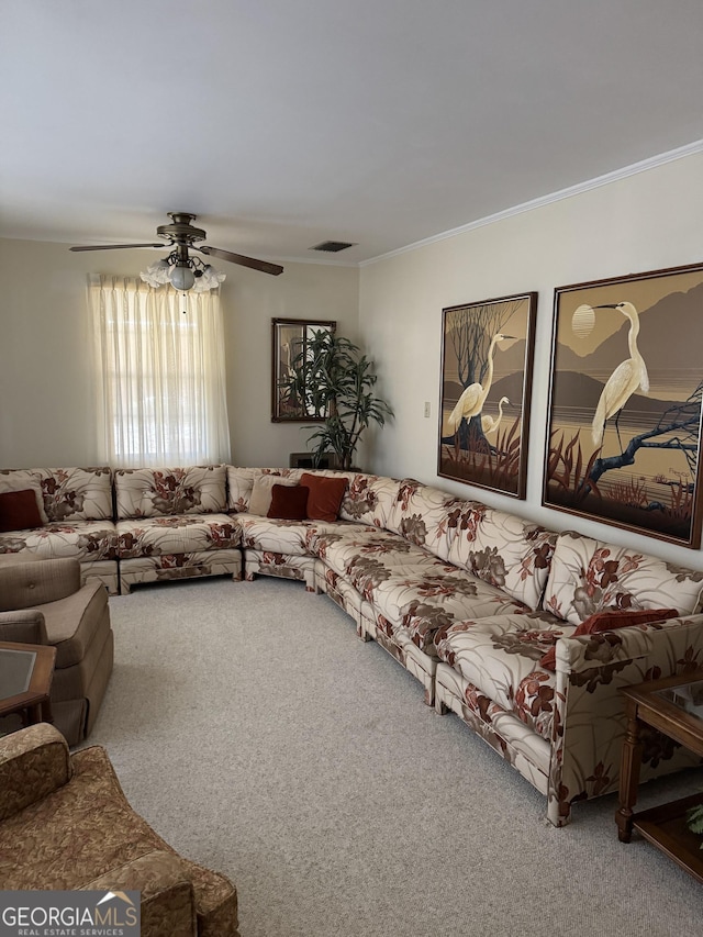 carpeted living room featuring crown molding and ceiling fan