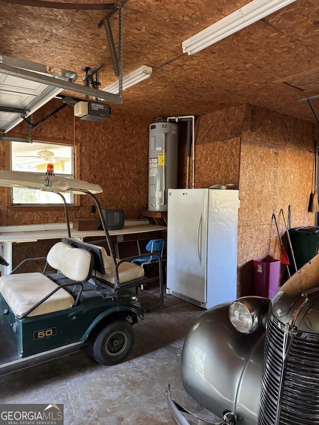 garage with white fridge, a garage door opener, and water heater