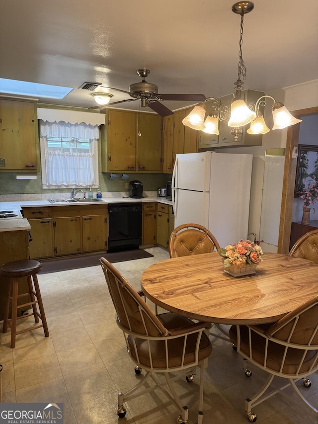 kitchen with sink, white refrigerator, dishwasher, pendant lighting, and ceiling fan