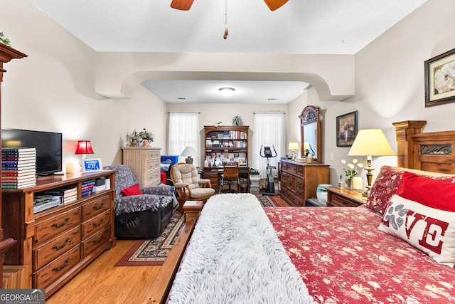 bedroom with hardwood / wood-style floors and a textured ceiling