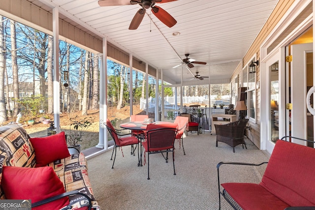 sunroom featuring ceiling fan