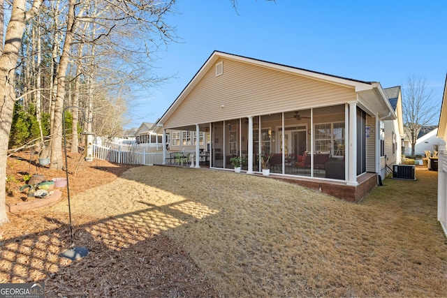 back of house with a yard, a sunroom, and central air condition unit