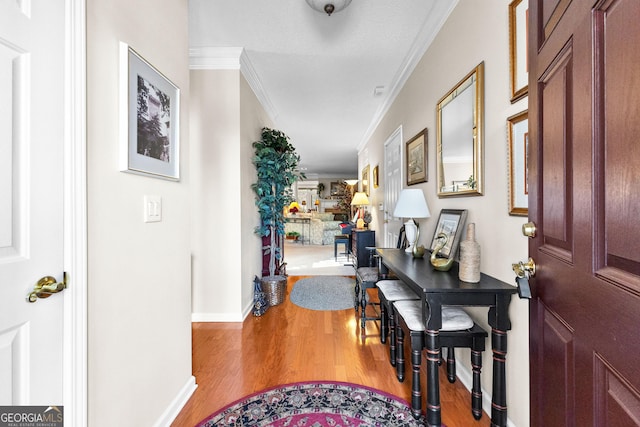 entrance foyer with hardwood / wood-style flooring and ornamental molding