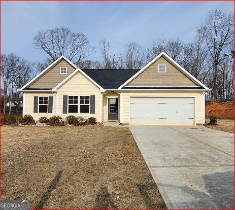 view of front of house with a garage and a front lawn