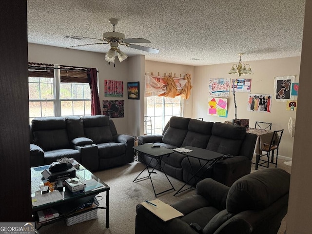 carpeted living room with ceiling fan and a textured ceiling