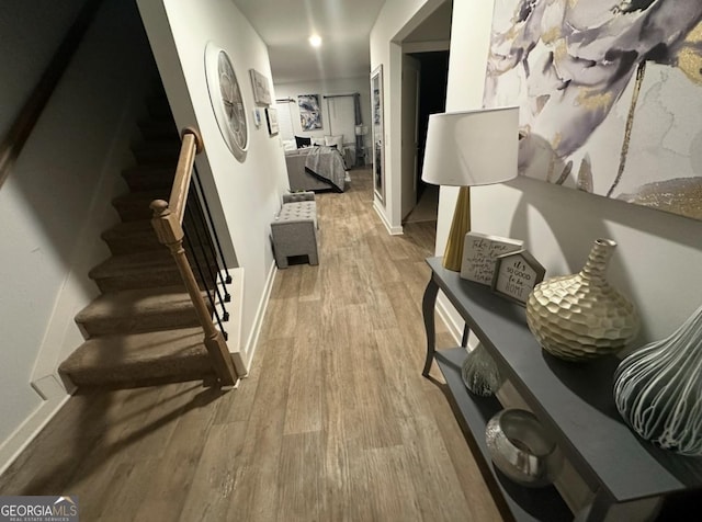 hallway with light hardwood / wood-style floors