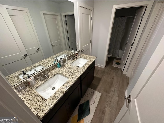 full bathroom with vanity, toilet, hardwood / wood-style floors, and shower / bath combo