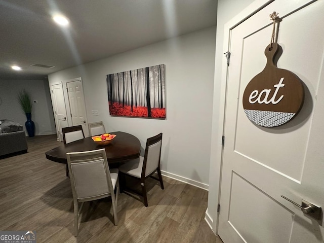 dining space with dark hardwood / wood-style floors