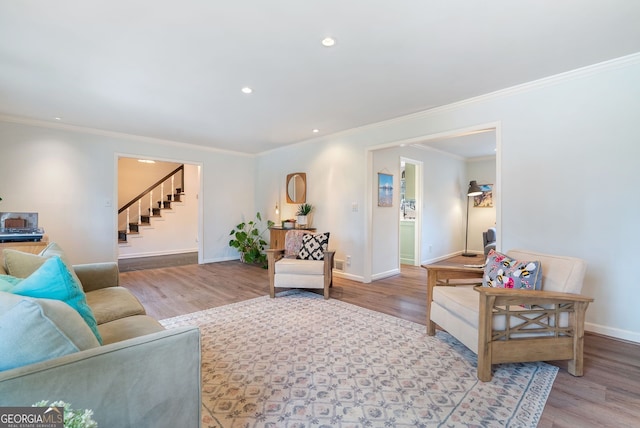 living room with crown molding and light wood-type flooring