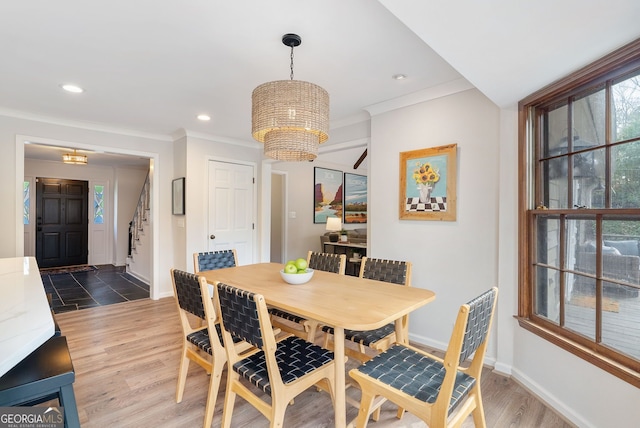 dining area with ornamental molding, a chandelier, and dark hardwood / wood-style flooring