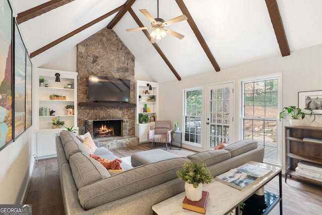 living room featuring hardwood / wood-style flooring, high vaulted ceiling, a fireplace, and beam ceiling