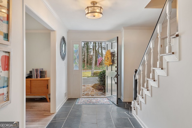 foyer entrance featuring crown molding