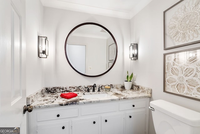 bathroom featuring vanity and toilet