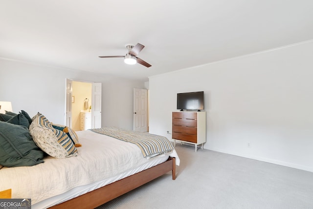 bedroom featuring crown molding, ceiling fan, carpet floors, and ensuite bath