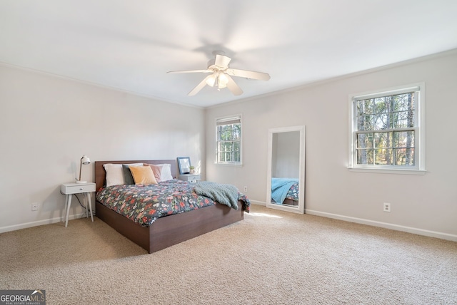 bedroom featuring crown molding, ceiling fan, and carpet flooring