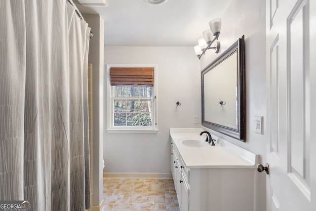 bathroom featuring walk in shower, vanity, and toilet