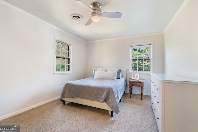 carpeted bedroom with crown molding and ceiling fan