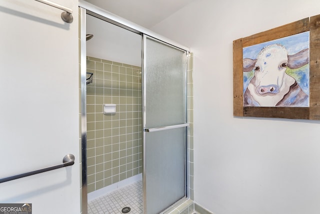 bathroom with a shower with shower door