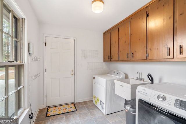 laundry area with cabinets, sink, and washing machine and clothes dryer