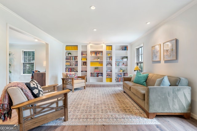 living room with wood-type flooring and crown molding