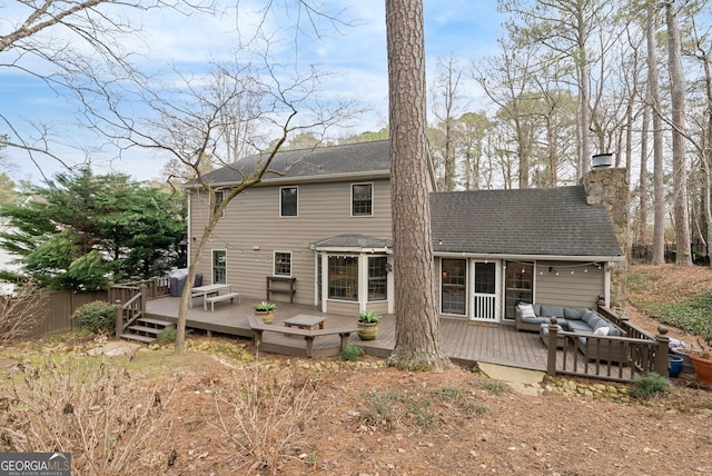 rear view of property with an outdoor hangout area and a deck