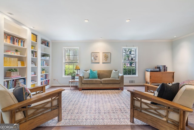 living room featuring hardwood / wood-style floors and ornamental molding