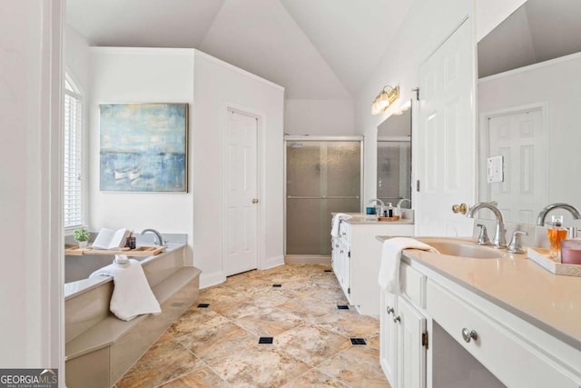 bathroom with vanity, vaulted ceiling, and shower with separate bathtub