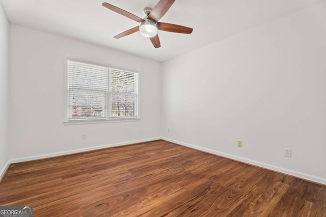 empty room featuring ceiling fan and dark hardwood / wood-style flooring