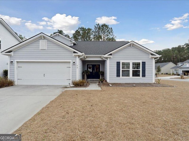 ranch-style house featuring a garage and a front lawn