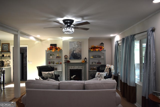 living room featuring ceiling fan and ornamental molding