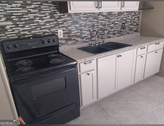 kitchen featuring sink, light tile patterned floors, black electric range, white cabinets, and decorative backsplash