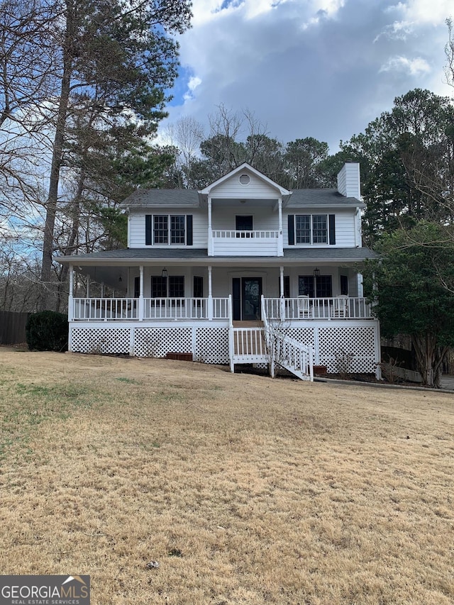 view of front facade with a front yard and a porch