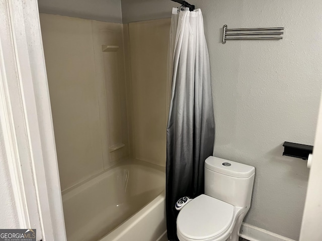 bathroom featuring toilet and shower / bath combo