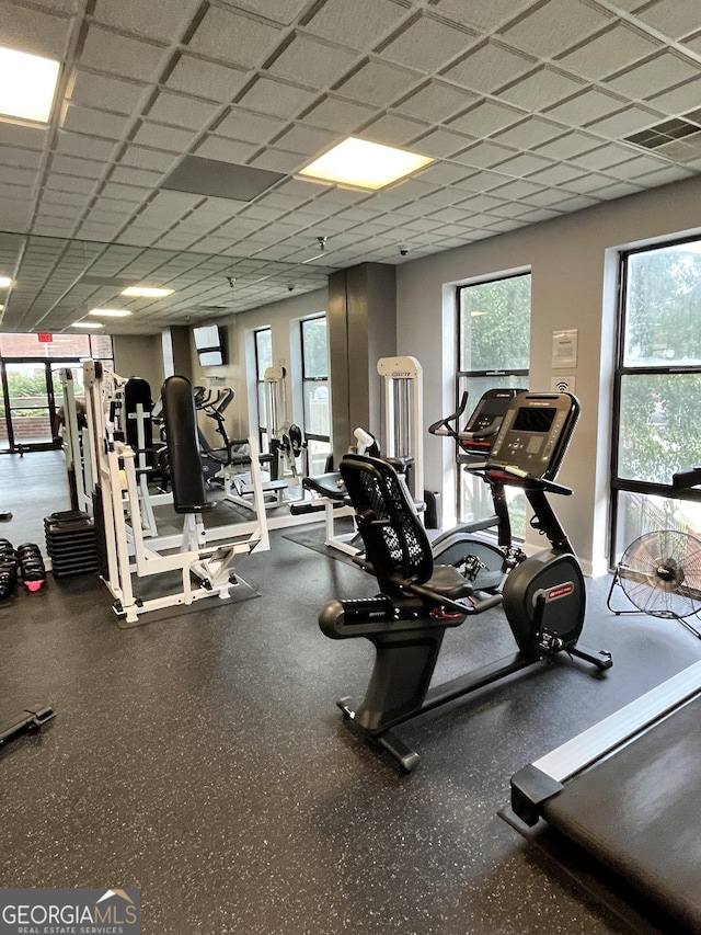 exercise room with a paneled ceiling