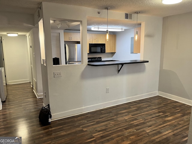 kitchen featuring light brown cabinetry, decorative light fixtures, stainless steel fridge, kitchen peninsula, and a textured ceiling