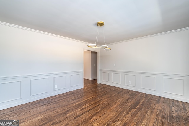 empty room featuring ornamental molding and dark hardwood / wood-style flooring