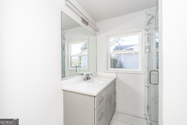 bathroom with vanity and a shower with door