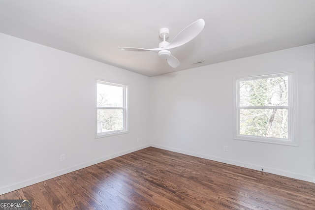 unfurnished room with dark hardwood / wood-style floors and ceiling fan