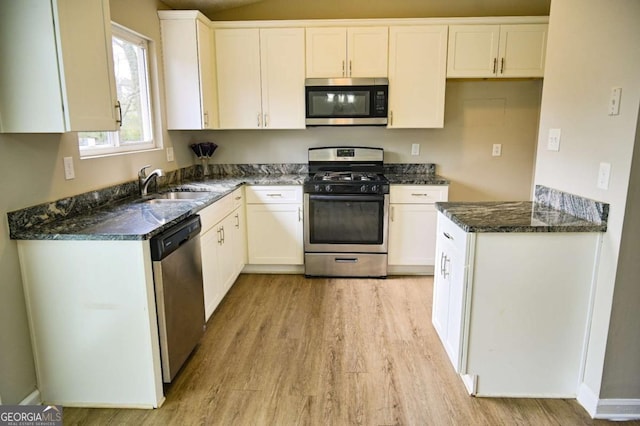 kitchen featuring stainless steel appliances, sink, and white cabinets