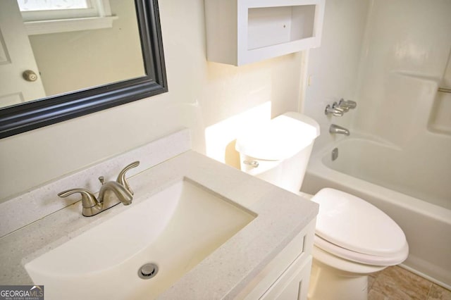 full bathroom with vanity, toilet, and  shower combination