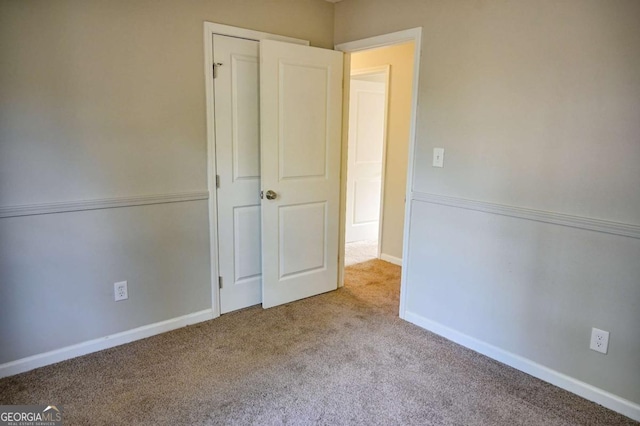 unfurnished bedroom featuring light carpet