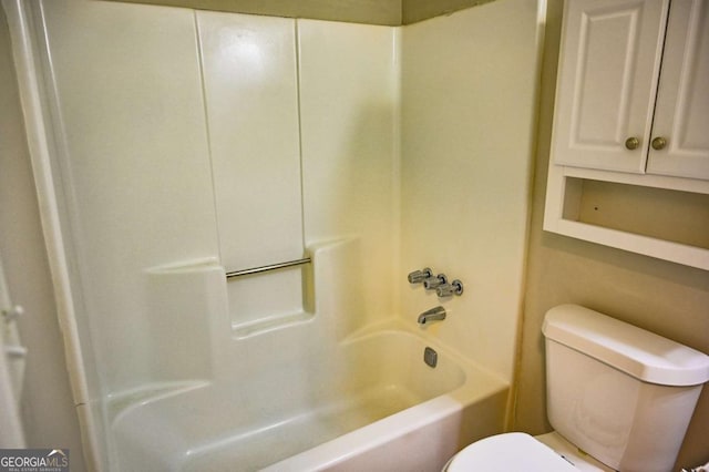 bathroom featuring washtub / shower combination and toilet