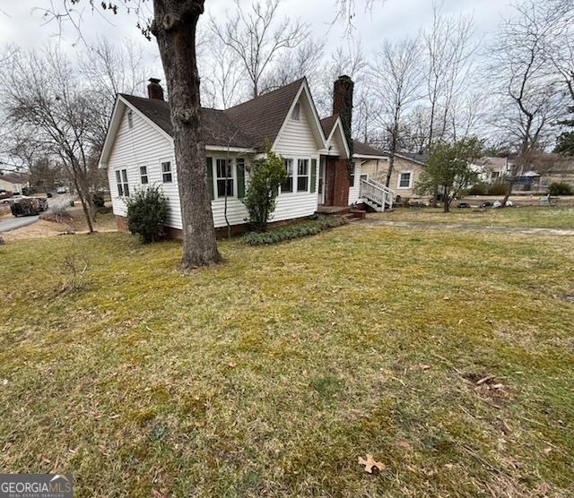 view of property exterior with a lawn