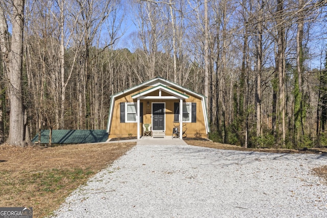 view of front of property with a forest view